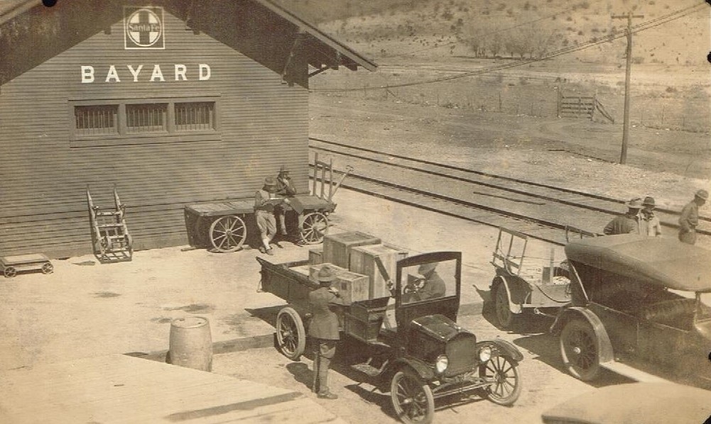 Fort Bayard Hospital personnel and vehicles at the Town of Bayard Railroad Depot during World War I.